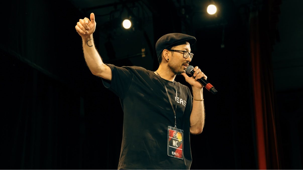 MC, arm raised